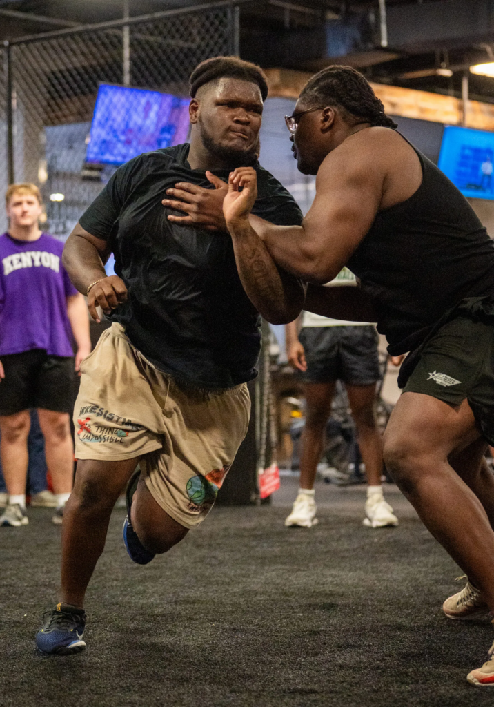 Trench Academy coach working one-on-one with a young athlete